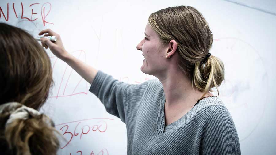 Foreign student writing on the board