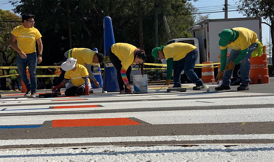 Colaboradores pintando cruce peatonal