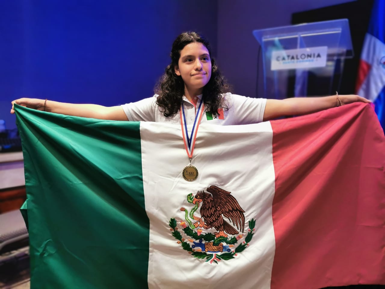 Karla posando junto a una bandera de mexico
