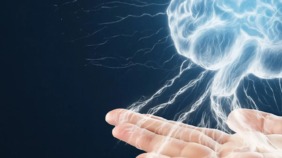 Outstretched hand holding a luminous, floating representation of a brain with simulated electrical connections.